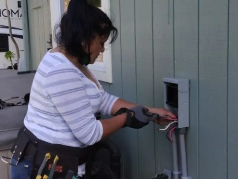 Licensed electrician wiring an exterior subpanel in Becker