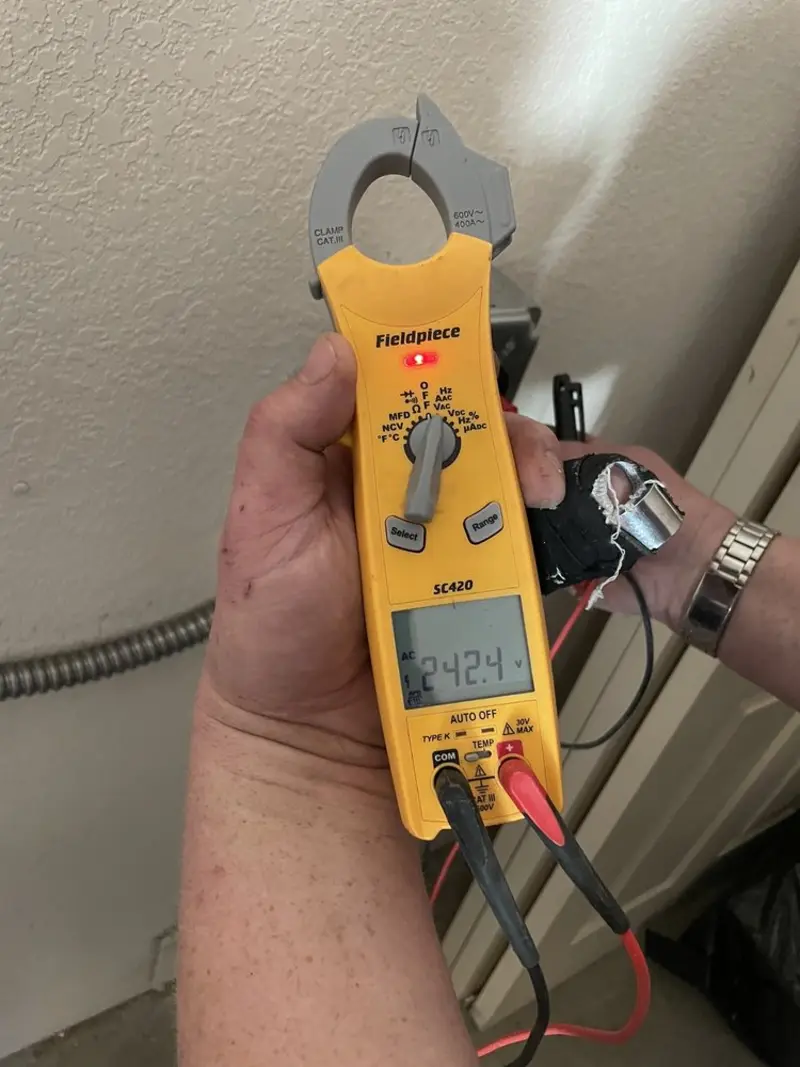 Voltage testing with clamp meter during Whole House Surge Protector in Becker